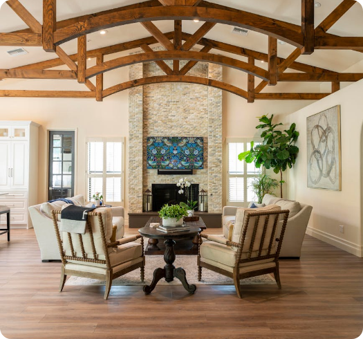 a living room with a wood ceiling and a fireplace