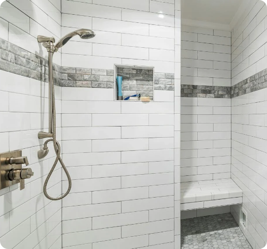 a shower with a shower head and a shelf