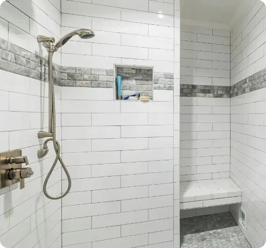 a shower with a shower head and a shelf